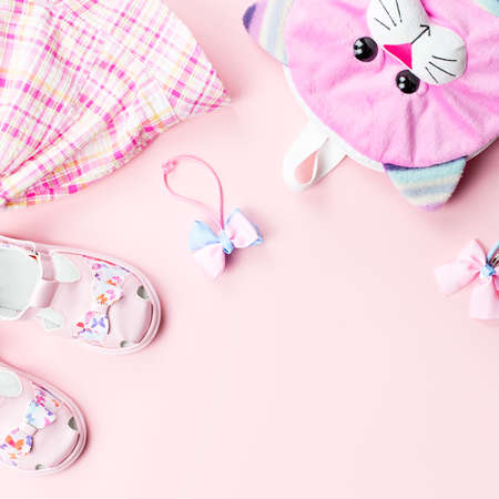 Little girl clothes and accessories on pink background. Top viewの写真素材
