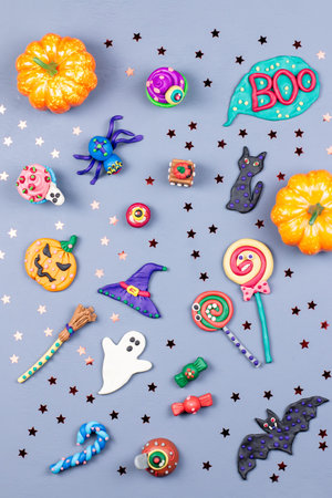 Halloween background with decorations. Black cat, bats, witches hat and broomstick with orange...