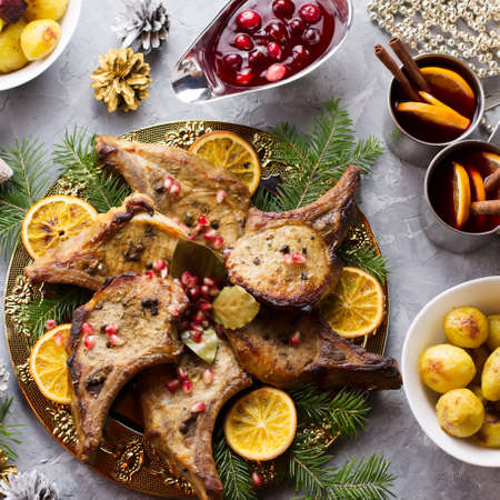 Delicious Christmas meal with roasted meat steak, Christmas Wreath salad, baked potato, grilled vegetables, cranberry sauce.の写真素材