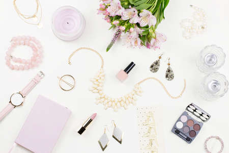 Feminine flat lay with woman fashion accessories, jewelry, cosmetics, coffee and flowers.の写真素材
