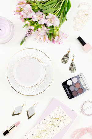 Feminine flat lay with woman fashion accessories, jewelry, cosmetics, coffee and flowers.の写真素材