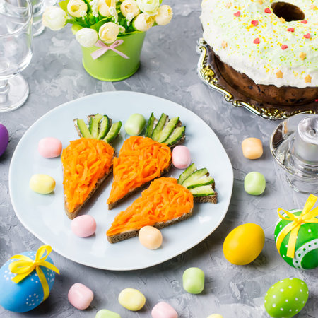Funny colorful Easter food for kids with decorations on table. Easter dinner concept