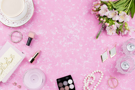 Feminine flat lay with women fashion accessories, jewelry, cosmetics, coffee and flowers.