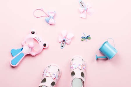 Baby girls accessories - sandals, toys. Childhood concept flat lay. Top viewの写真素材