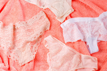 Various panties on bed background with flowers. Colorful women's underwear flatlayの写真素材