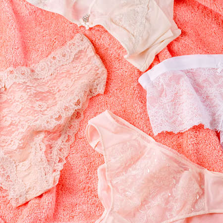 Lace lingerie on bed background with flowers and jewelry, top view, copy spaceの写真素材