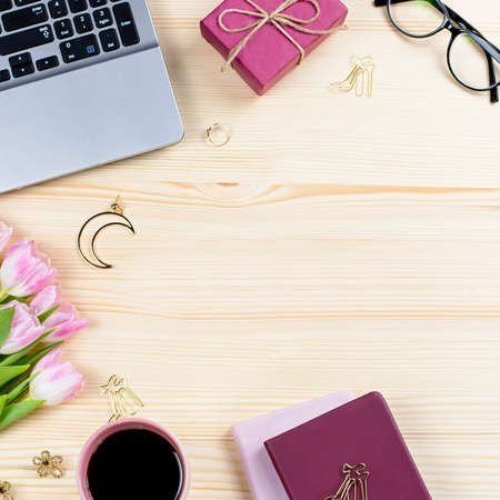 Woman office desk with notebooks, laptop, decor and accessoriesの写真素材