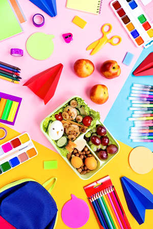 School lunchbox with healthy snack and funny foods- cutlets, vegetables, fruits, nuts. Back to school background.の写真素材