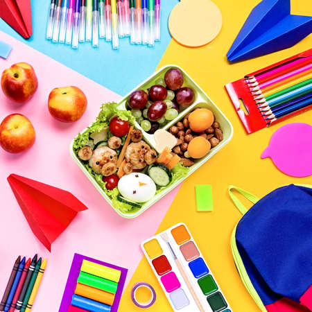 School lunchbox with healthy snack and funny foods- cutlets, vegetables, fruits, nuts. Back to school background.の写真素材