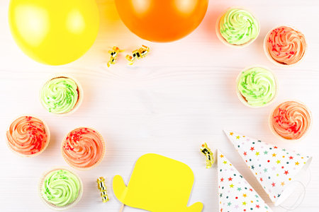 Colorful birthday party accessories on white. Wrapped gifts, confetti, balloons, party hats,...