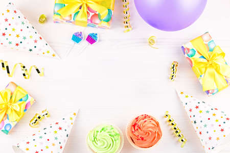 Birthday party accessories and event supplies background with wrapped gifts, confetti, balloons, party hats, decorations, copy spaceの写真素材