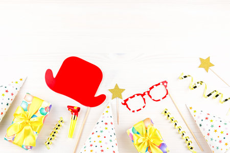 Birthday party accessories and event supplies background with wrapped gifts, confetti, balloons,...