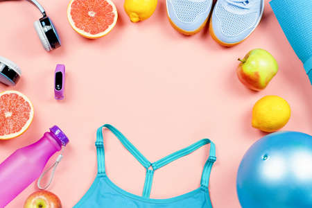 Layout of sport clothes and accessories for women with fruits on pink background.の写真素材