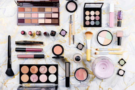 Make up items on marble table. Set of decorative cosmetics flat lay, top viewの写真素材