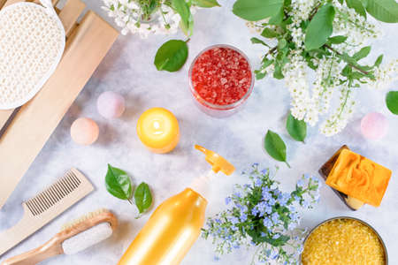 Natural body care products and accessories lay out with flowers and leaves. Eco friendly spa, beauty cosmetics concept with copy space.の写真素材