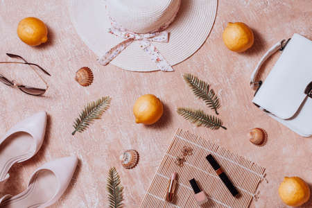 Fashion female clothes and accessories for beach destinations or summer vacation. Flat lay with woman white clothing and purse, make up items on terracota background, woman travel fashion conceptの写真素材