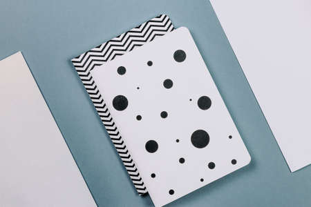 Minimal desk with note book, paper, stationery on grey background. Top viewの写真素材