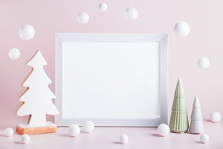 Christmas mockup frame with ceramic Christmas trees on pink background. Minimalistic Christmas card, copy spaceの写真素材
