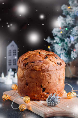 Christmas cake with raisins and candied fruit with Christmas decor and candlesの写真素材