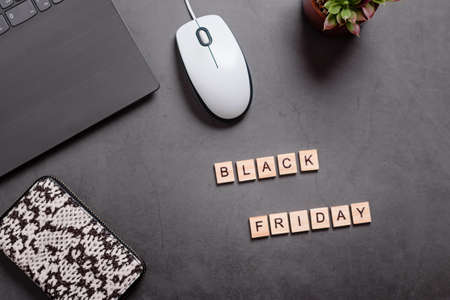 Black friday flat lay with wallet, laptop and succulent plant. Online shopping from home, safe shopping concept, top viewの写真素材