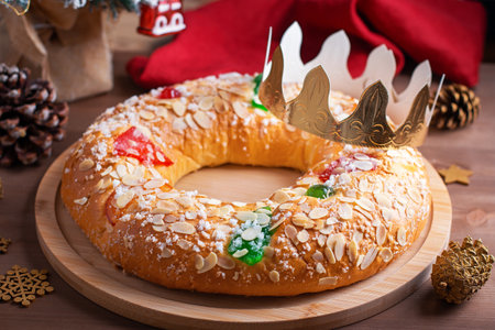 Traditional Epiphany cake Roscon de Reyes with crown on wooden table top closeup, top viewの写真素材