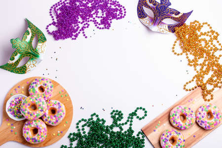 Mardi gras carnival doughnuts and beads, holiday celebration, baking, top viewの写真素材