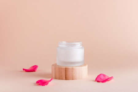 Facial cream with rose extract and rose petals in minimal still life.の写真素材