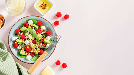 Light summer salad with raspberry, walnuts, avocado and cheeseの写真素材