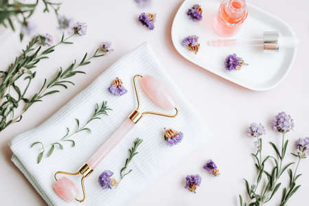 Gua sha beauty roller and rose extract facial serum, top viewの写真素材