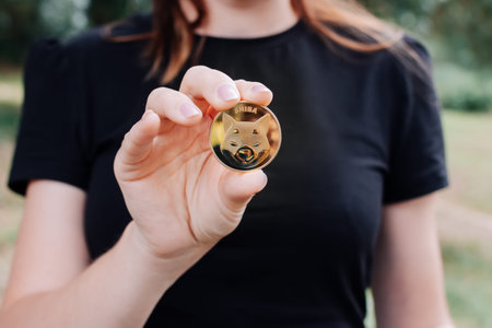 Empuriabrava, Spain, June 2021 - Shiba token in womans hand on natural background