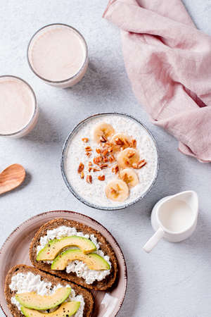 Protein rich breakfast with overnight oats, avocado toast and peanut butter shakeの写真素材