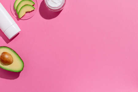 Avocado skin care cosmetics flat lay frame on pinkの写真素材
