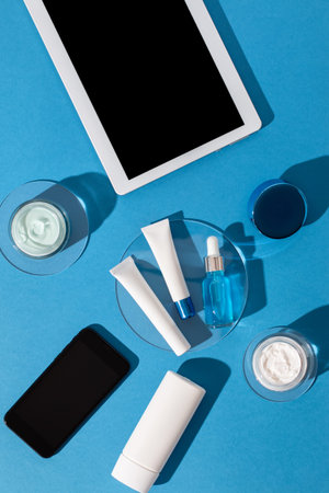 Skin care cosmetics protecting from gadgets blue light on blue background