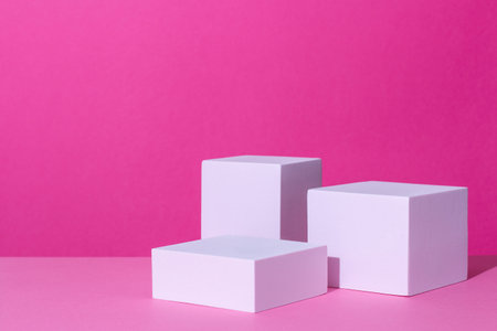 Empty podium or stand for product showcase on pink background. Cosmetic product stage in bright pink...