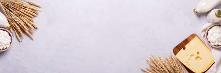 Shavuot flat lay with dairy products and wheat on light gray background, Happy Shavuot web banner. Jewish Shavuot holiday frame with dairy foods and quote happy Shavuot, top viewの写真素材