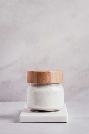 Cosmetic product in eco friendly packaging on marble tray on light gray background. Beauty product on marble podium, copy spaceの写真素材