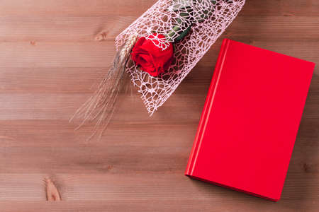 Red rose and red book on pink background, Sant Jordi holiday cardの写真素材