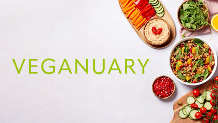 Colorful vegetarian or veganuary feast on table and quote Veganuary, frame with plates, view from above, top view. Healthy diet or lifestyle concept with green, healthy salads and hummus.の写真素材