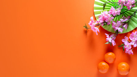 Chinese or lunar new year flat lay with paper decorations, mandarins and flowers on orange...