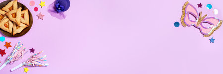 Purim carnival background with traditional cookies, costume accessories and decor on pastel violet background, web banner, copy spaceの写真素材