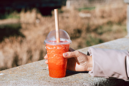 Glass of strawberry and mango bubble tea on city background, bubble tea closeup, blurred background. Lifestyle, toned imageの写真素材