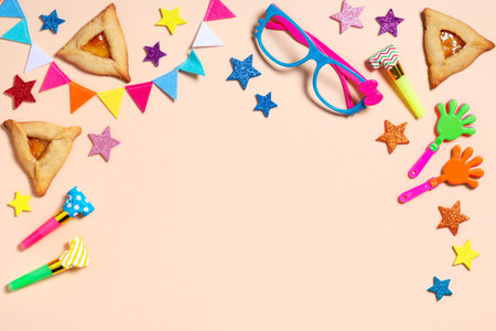 Purim border, carnival background with traditional cookies, costume accessories and decor on bright light background, copy spaceの写真素材