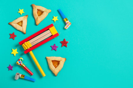 Purim border, carnival background with traditional hamantaschen cookies, costume accessories and decor on bright green background, copy spaceの写真素材