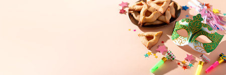 Purim web banner with hamantaschen cookies, carnival mask, holiday decor in hard lightの写真素材