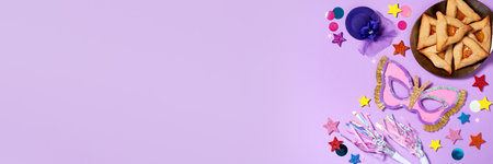 Purim carnival background with traditional cookies, costume accessories and decor on pastel violetの写真素材