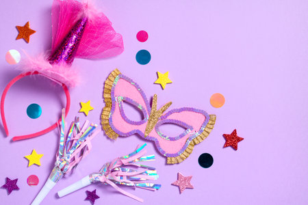 Purim carnival background with traditional cookies, costume accessories and decor on pastel violetの写真素材