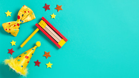Purim border, carnival background with traditional hamantaschen cookies, costume accessories and decor on bright green background, copy spaceの写真素材