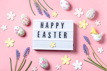 Easter card with flower design eggs, hyacinths, lightbox with Happy Easter quote on pastel pink background, Easter frame in pastel colors, top viewの写真素材