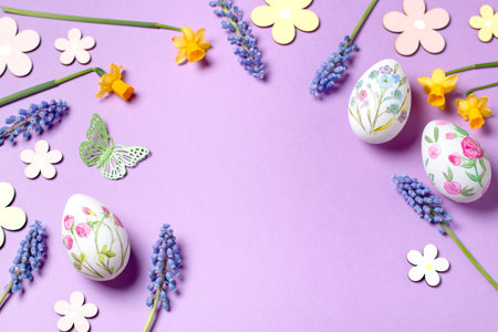 Easter card with flower design eggs, hyacinths, flower decor on pastel purple backgroundの写真素材
