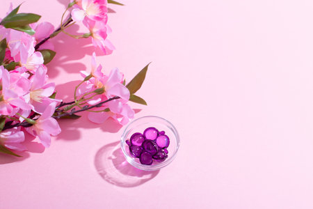 Scalp Massage and Cleansing Shampoo Brush with hair vitamins on pink backgroundの写真素材